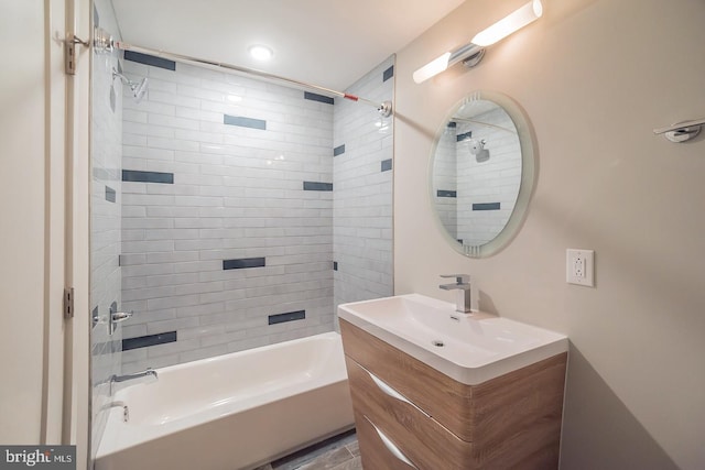 bathroom with vanity and tiled shower / bath combo