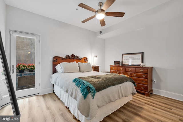 bedroom with light wood-type flooring, access to outside, and ceiling fan