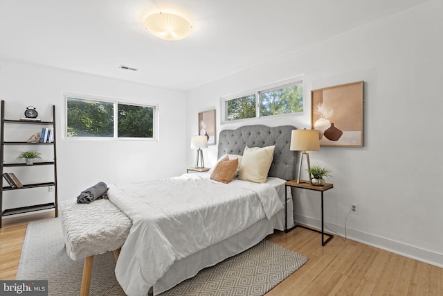 bedroom featuring light wood-type flooring and multiple windows