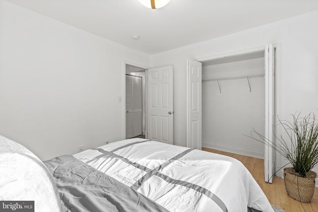 bedroom featuring light hardwood / wood-style flooring and a closet