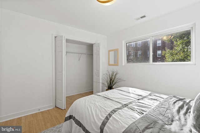 bedroom featuring a closet and light hardwood / wood-style flooring