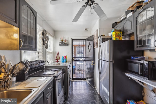 kitchen featuring independent washer and dryer, ceiling fan, and appliances with stainless steel finishes