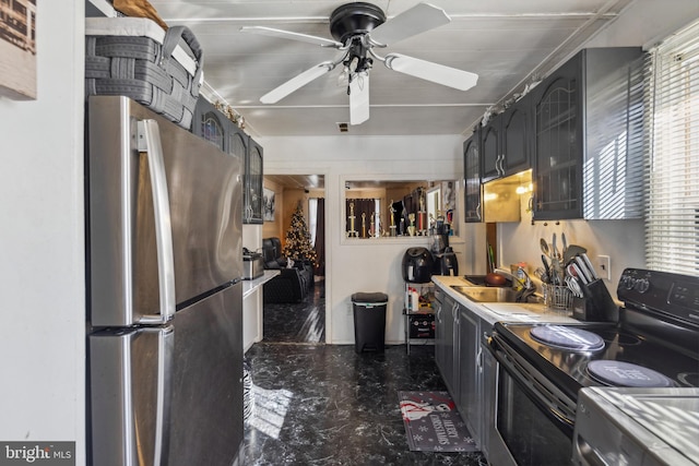 kitchen with stainless steel refrigerator, ceiling fan, black / electric stove, and sink