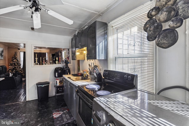 kitchen with range with electric stovetop, sink, ceiling fan, and washer / clothes dryer