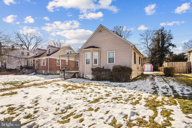 view of snow covered rear of property