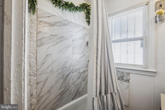 bathroom featuring shower / bath combo with shower curtain