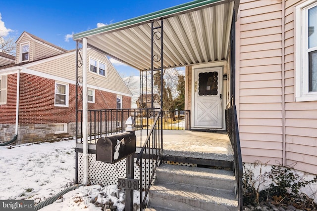 view of snow covered property entrance