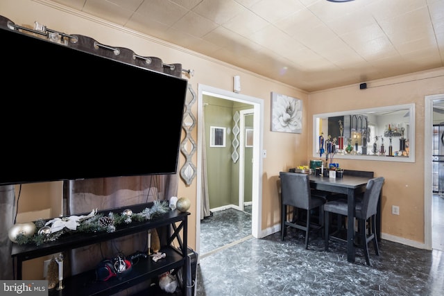 dining space featuring ornamental molding and bar area