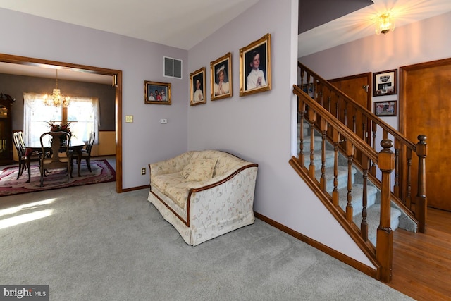 sitting room featuring carpet and a chandelier