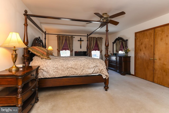 bedroom with ceiling fan, carpet floors, and a closet