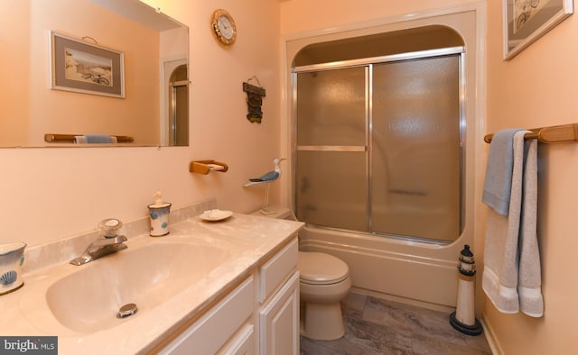 full bathroom with vanity, toilet, and bath / shower combo with glass door