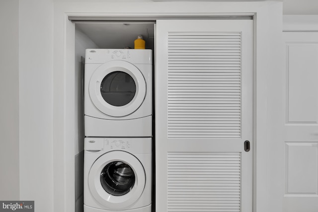 clothes washing area with stacked washer / drying machine