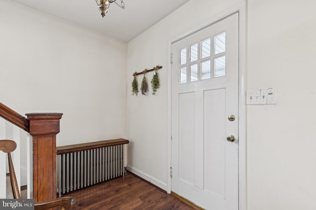 entrance foyer with dark hardwood / wood-style floors and radiator heating unit