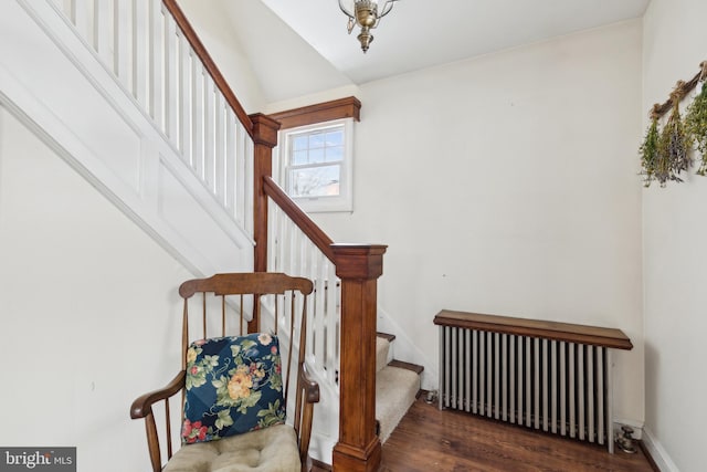 stairs with radiator heating unit and hardwood / wood-style flooring