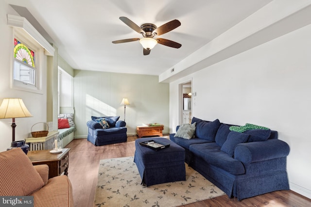 living room featuring ceiling fan and wood-type flooring