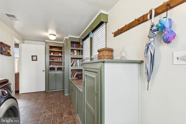 interior space with washer / dryer and ornamental molding