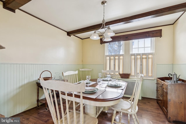 dining space featuring beam ceiling, dark wood-type flooring, and a notable chandelier