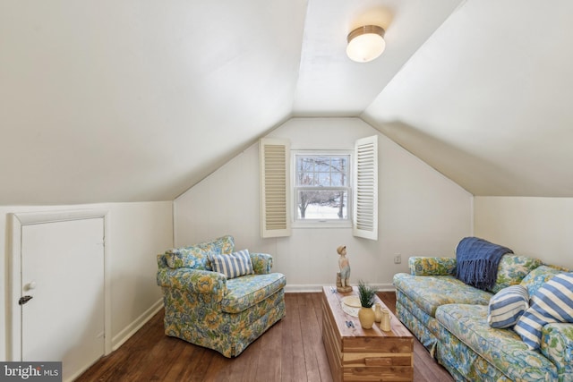 sitting room featuring dark wood-type flooring and vaulted ceiling