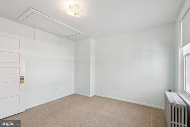 carpeted empty room with radiator