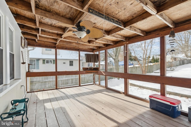 unfurnished sunroom with ceiling fan