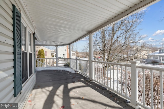 snow covered deck with covered porch