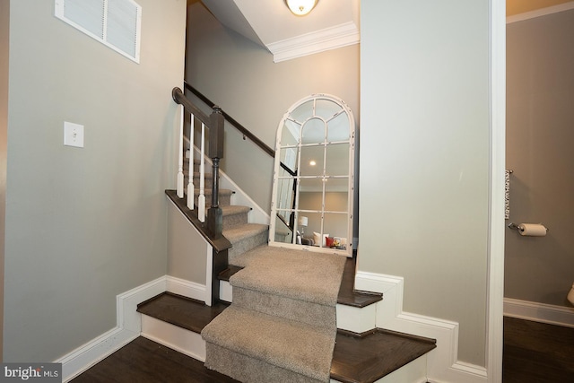 stairway featuring hardwood / wood-style floors and ornamental molding