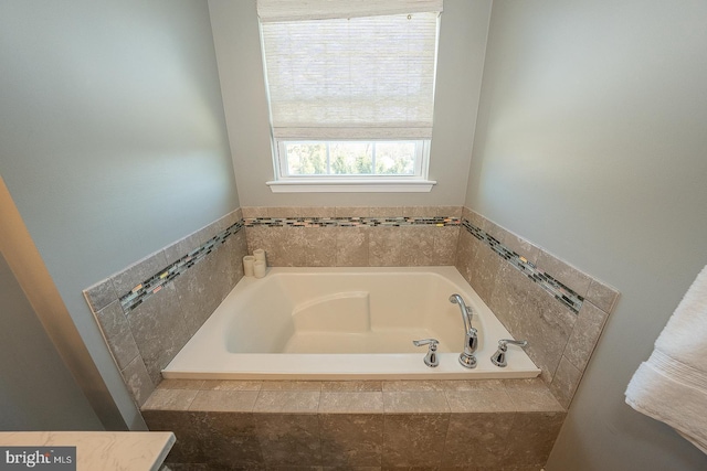 bathroom with tiled bath