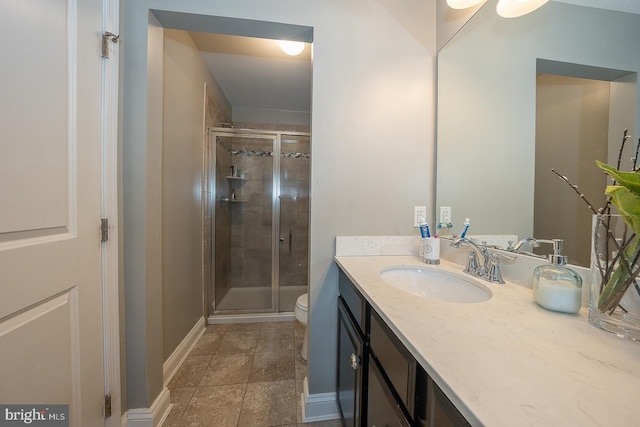 bathroom with vanity, toilet, and walk in shower