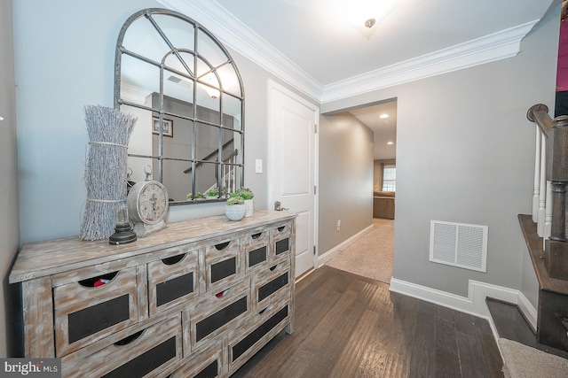 corridor featuring dark wood-type flooring and ornamental molding