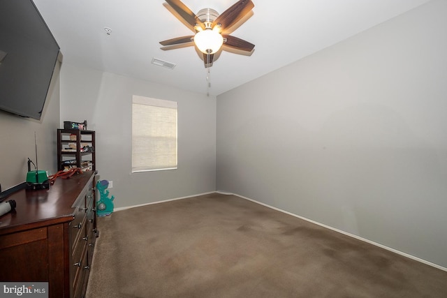 office space with dark carpet and ceiling fan