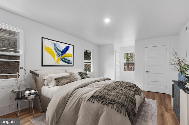 bedroom with dark wood-type flooring