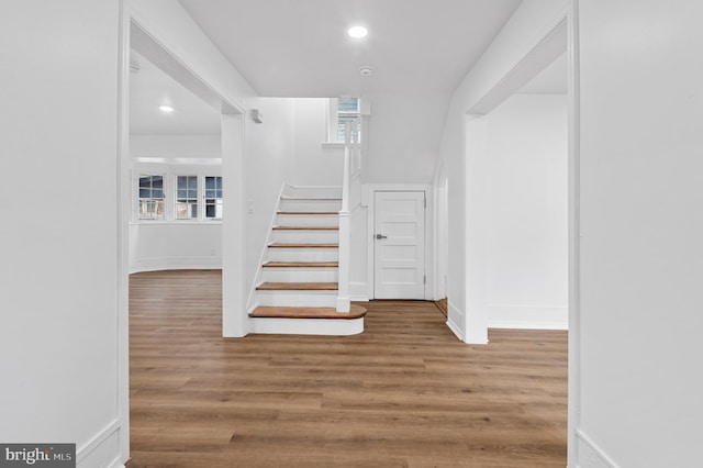 stairway with hardwood / wood-style floors