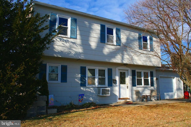 view of front of house with a garage and a front lawn