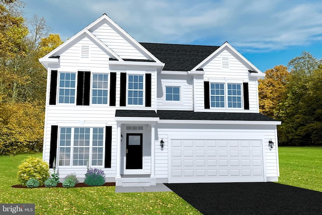 view of front of home with a front lawn and a garage