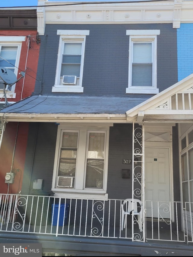 view of property exterior featuring covered porch and cooling unit