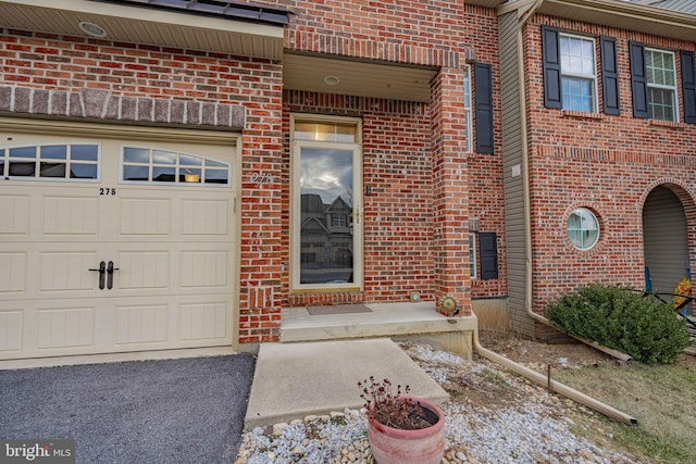 doorway to property with a garage