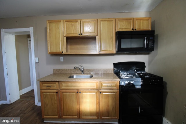 kitchen with sink, dark wood-type flooring, and black appliances