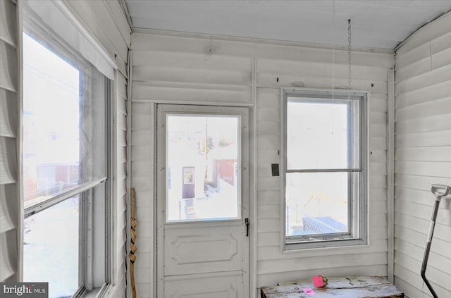 doorway featuring wooden walls