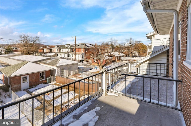 view of snow covered back of property