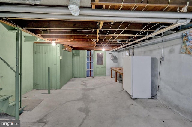 basement with white refrigerator