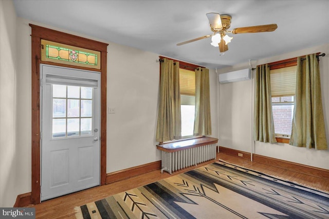 entryway with a wall unit AC and light hardwood / wood-style floors