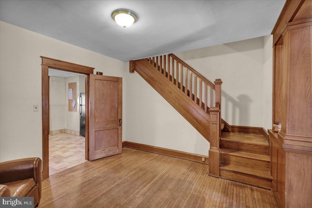 staircase with hardwood / wood-style flooring