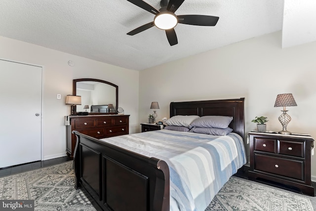 bedroom with ceiling fan and a textured ceiling