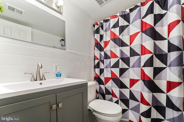 bathroom with decorative backsplash, vanity, tile walls, toilet, and curtained shower