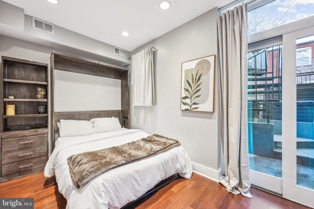 bedroom featuring access to outside and dark wood-type flooring