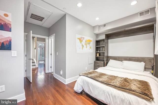 bedroom with dark hardwood / wood-style flooring