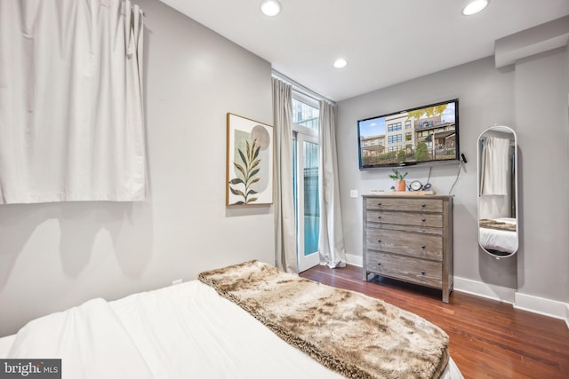 bedroom with dark wood-type flooring