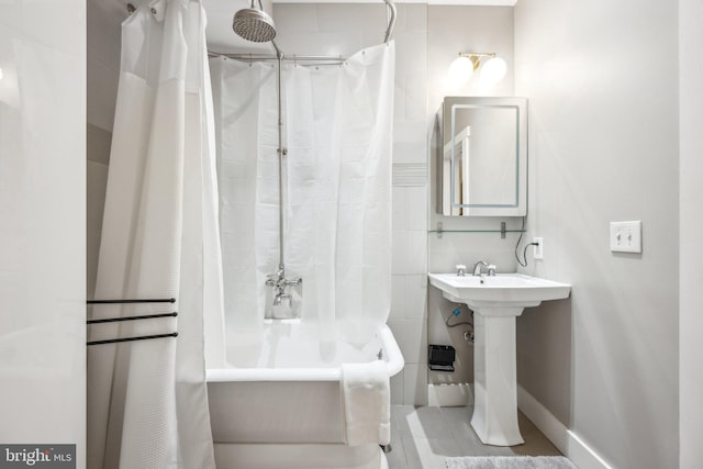 bathroom with shower / bath combination with curtain and sink