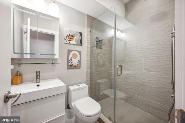 bathroom featuring vanity, toilet, and an enclosed shower