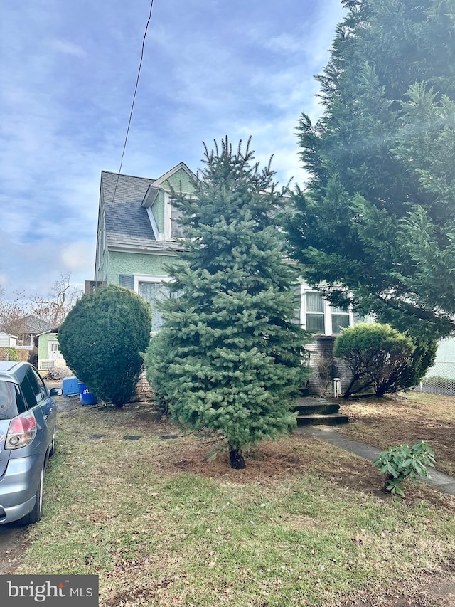 view of side of property with a lawn